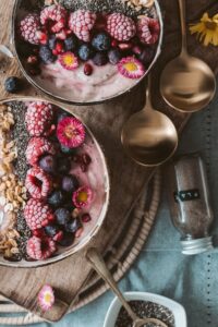 health products: two bowls of chia pudding with berries and chia seeds.