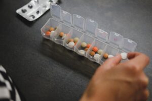 A plastic container with pills in it.